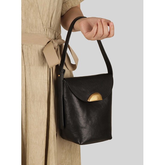 A high-quality tote bag worn under the armpit of one shoulder