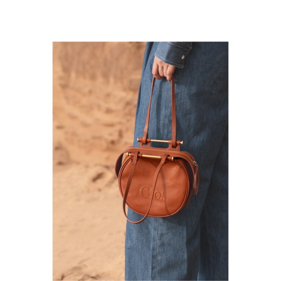 Crossbody bag on one shoulder with a top layer of calfskin commuter tote