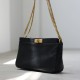 Women's commuter chain bag is worn crossbody over one shoulder