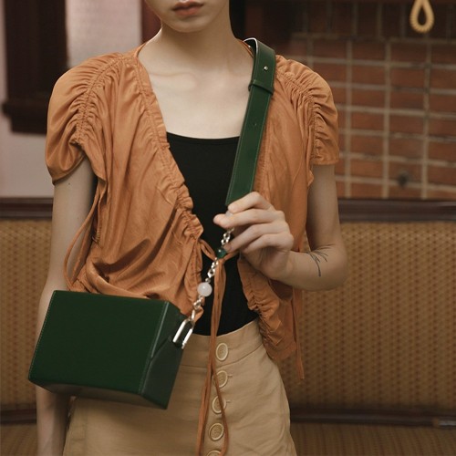 klare crossbody in signature canvas with rivets